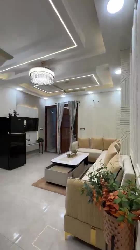 Dining and living area with wall panelling and marble table – GharVistaar interior design