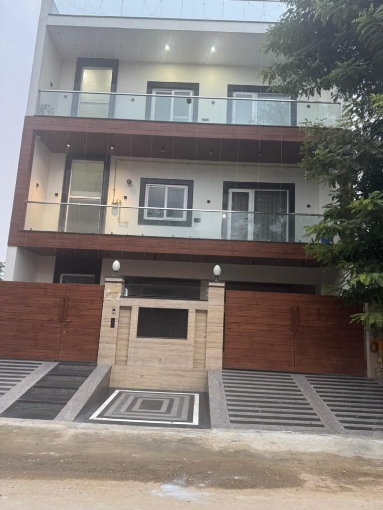 Four-floor builder floor front elevation with jali screen, glass balconies and wooden cladding by GharVistaar builder floor construction Delhi