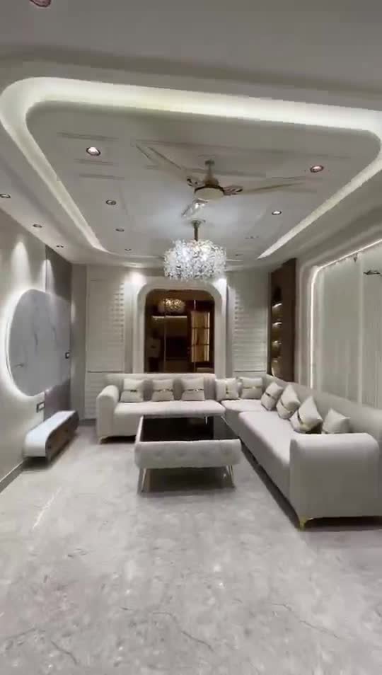 Luxury living room with layered false ceiling, chandelier and marble floor – GharVistaar interior design